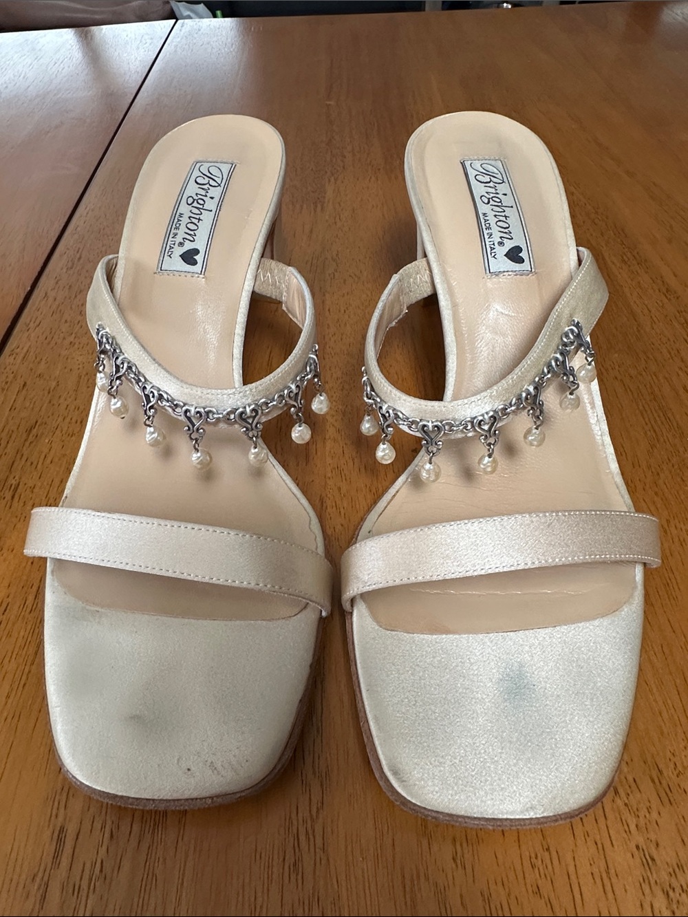 Brighton cream satin open toe low heel dress shoes. Has signature Brighton charm